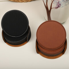 Leather table mats in different colors. Concept shot, top view. Custom background view of leather table coaster. Stitched and leather table coaster