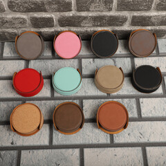 Leather table mats in different colors. Concept shot, top view. Custom background view of leather table coaster. Stitched and leather table coaster