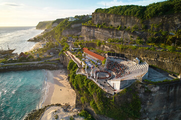 The amphitheater of the local show Kecak Dance at Melasti Beach over a cliff near the ocean on the...