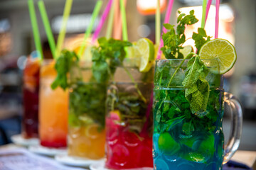 Diverse Beverage Selection: Colorful Pitchers with Limes and Herbs