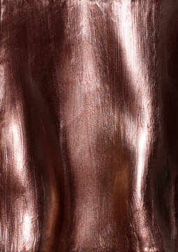 Copper metallic shimmering glossy nail polish composition background. Cosmetic makeup product texture