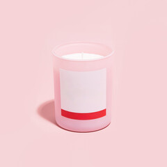 Pink candle with blank label on pink background