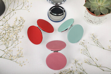 Leather Round pocket makeup mirror in different colors. Concept shot, top view. Custom background,...