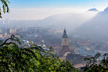 Sunrise and morning mist in Brasov city. Transylvania, Romania - obrazy, fototapety, plakaty