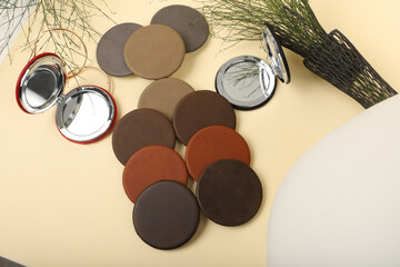Leather Round pocket makeup mirror in different colors. Concept shot, top view. Custom background, pocket makeup mirror. Travel pocket mirror, free space for text.