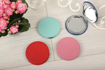 Leather Round pocket makeup mirror in different colors. Concept shot, top view. Custom background, pocket makeup mirror. Travel pocket mirror, free space for text.