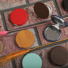 Leather Round pocket makeup mirror in different colors. Concept shot, top view. Custom background, pocket makeup mirror. Travel pocket mirror, free space for text.