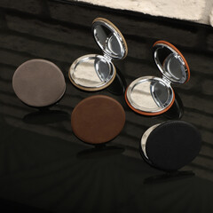 Leather Round pocket makeup mirror in different colors. Concept shot, top view. Custom background, pocket makeup mirror. Travel pocket mirror, free space for text.
