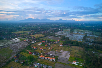 Aerial view of rice plantations and a hill village from a drone. Rice terraces on the island of Bali.