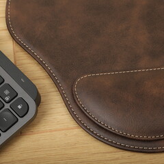 Leather mousepads in dark brown colors. Concept shot, top view. Custom background, leather mousepad. Free space for text.