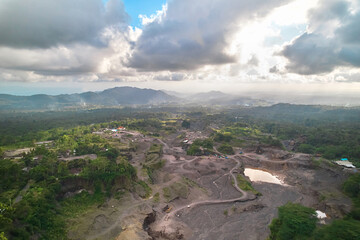 A beautiful valley under an active volcano. An old river made of ash and lava where minerals are mined.