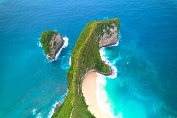 Cinematic aerial landscape shots of the beautiful island dinosaur of Nusa Penida. Huge cliffs by the shoreline and hidden dream beaches with clear water. - obrazy, fototapety, plakaty