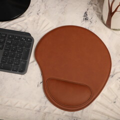 Leather mousepads in light brown colors. Concept shot, top view. Custom background, leather...