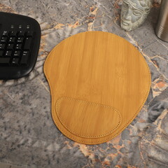 Leather mousepads in bamboo colors. Concept shot, top view. Custom background, leather mousepad. Free space for text.