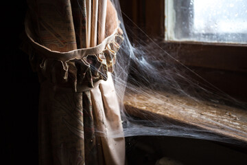 Curtain with spider web in an abandoned old house
