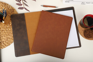 Leather portfolio. Concept shot, top view, portfolio in brown colors and leather pen. Custom...