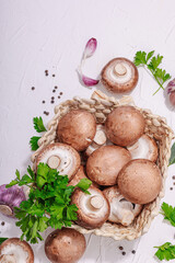 Raw brown royal champignons in the basket. Cooking vegan food concept. Garlic, greens, spices