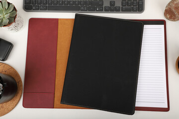 Leather portfolio. Concept shot, top view, portfolio in different colors and leather pen. Custom background flap portfolio view. Portfolio and accessories.