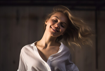 Joyful young blond woman having fun, dancing with happy smiling face and relaxed emotion