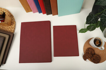Leather portfolio. Concept shot, top view, portfolio in rose colors and leather pen. Custom background flap portfolio view. Portfolio and accessories.
