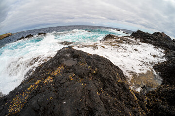 The rocky shore and natural pools of El Caleton. Garachico. Tenerife. Canary islands. Spain. Fisheye lens.