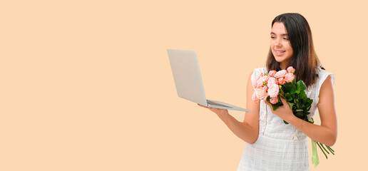 Happy young woman with laptop and rose flowers on beige background with space for text