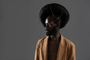 Fashion african-american bearded gay man with bright makeup and weird fashionable retro hairstyle...