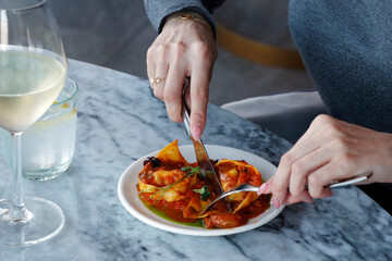 pasta dish lobster stuffed ravioli and glass of pairing wine in close up, food photography