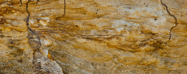 Sand quarry. Sedimentary rocks with a high content of iron oxide. Red soil, loam. The texture of the soil.