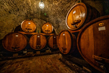 Wine barrels in a winery in Montepulciano, Tuscany, Italy