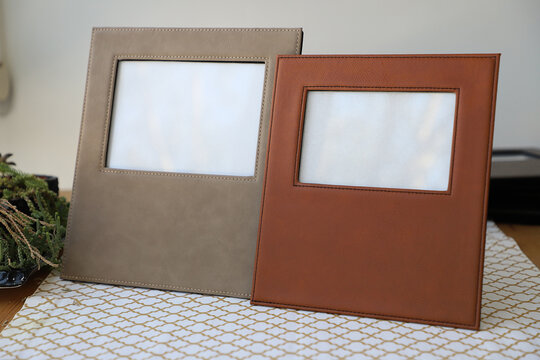 Leather photo frame in different colors. Concept shot. Custom background, Creative composition of modern living room interior. Free space for text, picture or photograph . Stylish accessory for home.