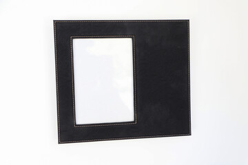 Leather photo frame in black colors. Concept shot. Custom background, Creative composition of modern living room interior. Free space for text and picture or photograph . Stylish accessory for home.