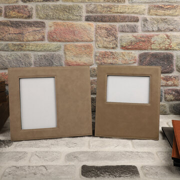 Leather photo frame in different colors. Concept shot. Stone wall background, Creative composition of modern living room interior. Free space for text and picture or photograph . Stylish home accessor