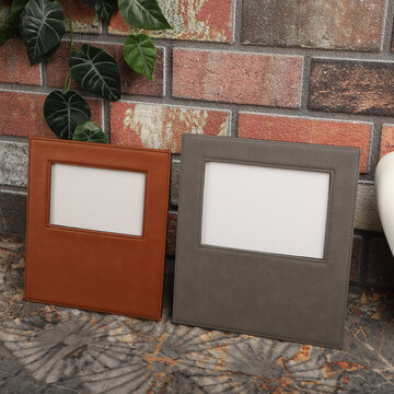 Leather photo frame in different colors. Concept shot. Stone wall background, Creative composition of modern living room interior. Free space for text and picture or photograph . Stylish home accessor
