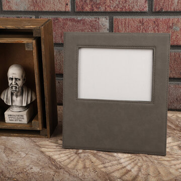 Leather photo frame in gray colors. Concept shot. Custom background, Creative composition of modern living room interior. Free space for text and picture or photograph . Stylish accessory for home.