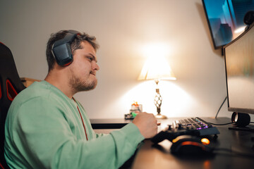 Angry gamer gesturing in front of the computer at home