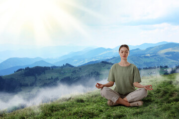 Woman meditating in foggy mountains at sunrise