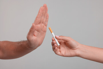 Stop smoking concept. Man refusing cigarette on grey background, closeup - obrazy, fototapety, plakaty