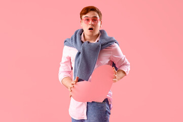 Shocked young man with blank speech bubble on pink background. Valentine's Day celebration