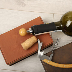 Wine opener set in leather box. Colorful leather boxes. Wine opener and cork. Close-up, top view,...
