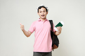 Asian man backpacker holding passport. digital nomad and travelling concept. on isolated background