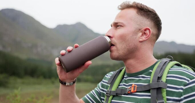 Hiking, fitness or tired man drinking water in forest for training, adventure or morning exercise in nature. Sports, fatigue or sweaty guy backpacker with hydration break in jungle for travel journey