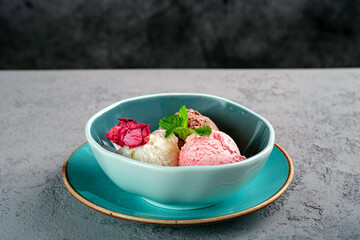 Different ice cream balls in Minsk with mint. Gelato ice cream with vanilla, pistachios and chocolate.