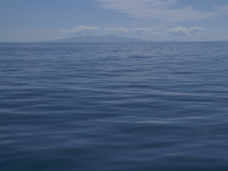 Sailing on calm waters of Hauraki Gulf towards Coromandel Peninsula in distance. Location: Auckland New Zealand