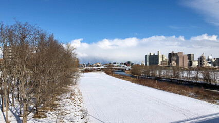 Fototapeta na wymiar Winter river and sky, city streetscape