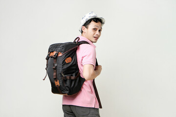 attractive asian man backpacker back pose portrait. travelling concept. on isolated background