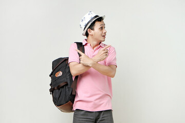 Asian man backpacker with confused expression. travelling concept. on isolated background
