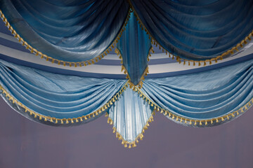 blue curtain with gold ribbon
