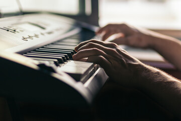 man hands playing the piano close-up. musical keyboard