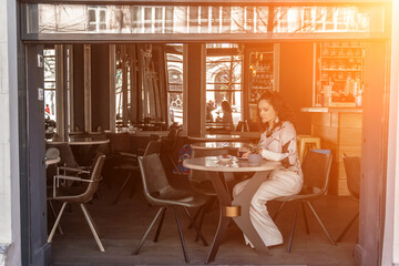 Woman cafe coffee breakfast. Portrait of an adult beautiful woman in an elegant suit in a cafe